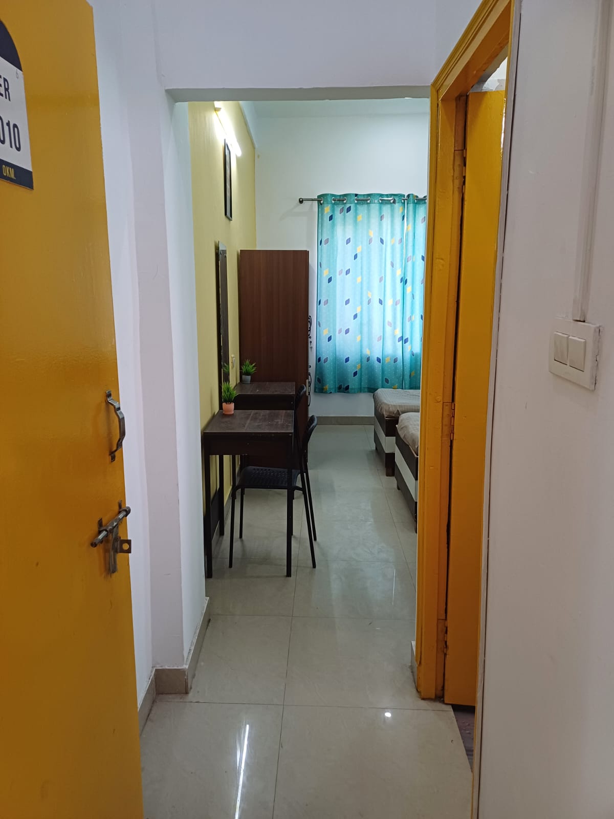 Room entrance and hallway view at Stag House Hostels