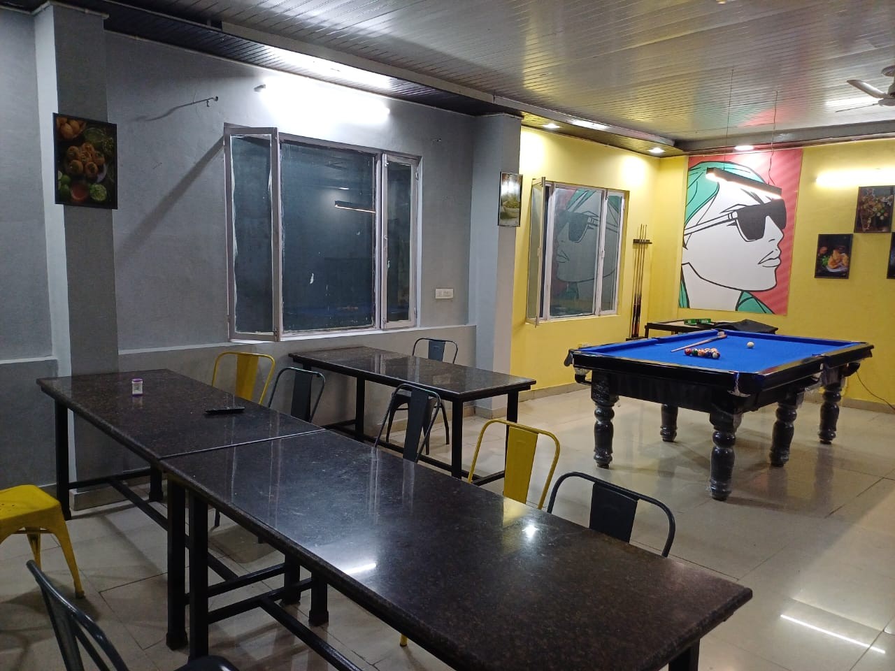 Dining and study table area at Stag House Hostels