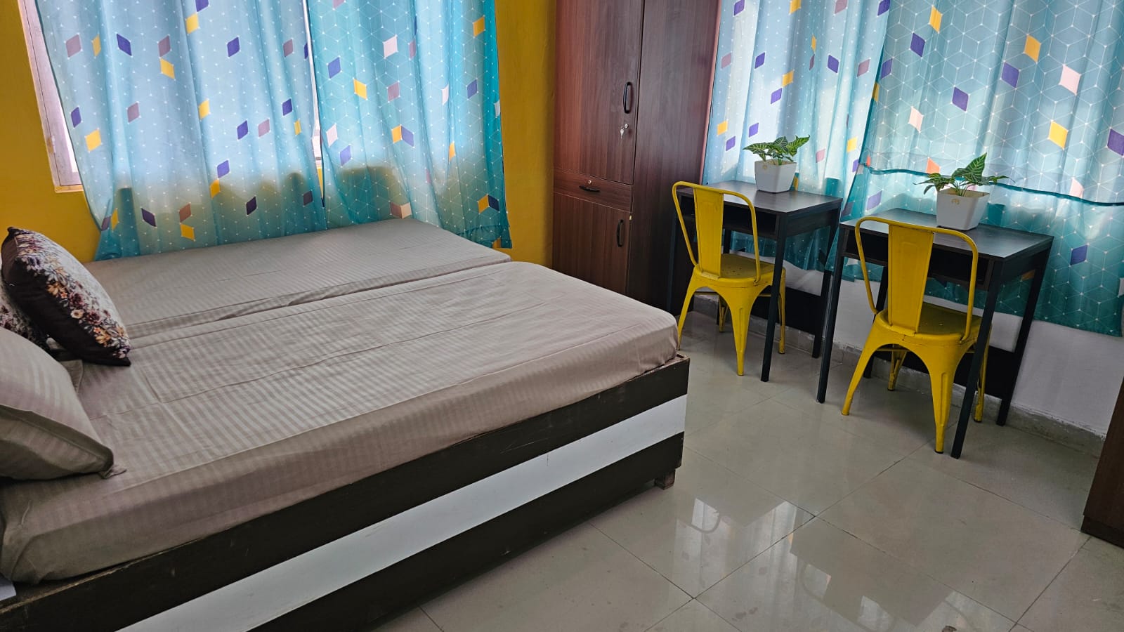 Student room with bed and study desk at Stag House Hostels