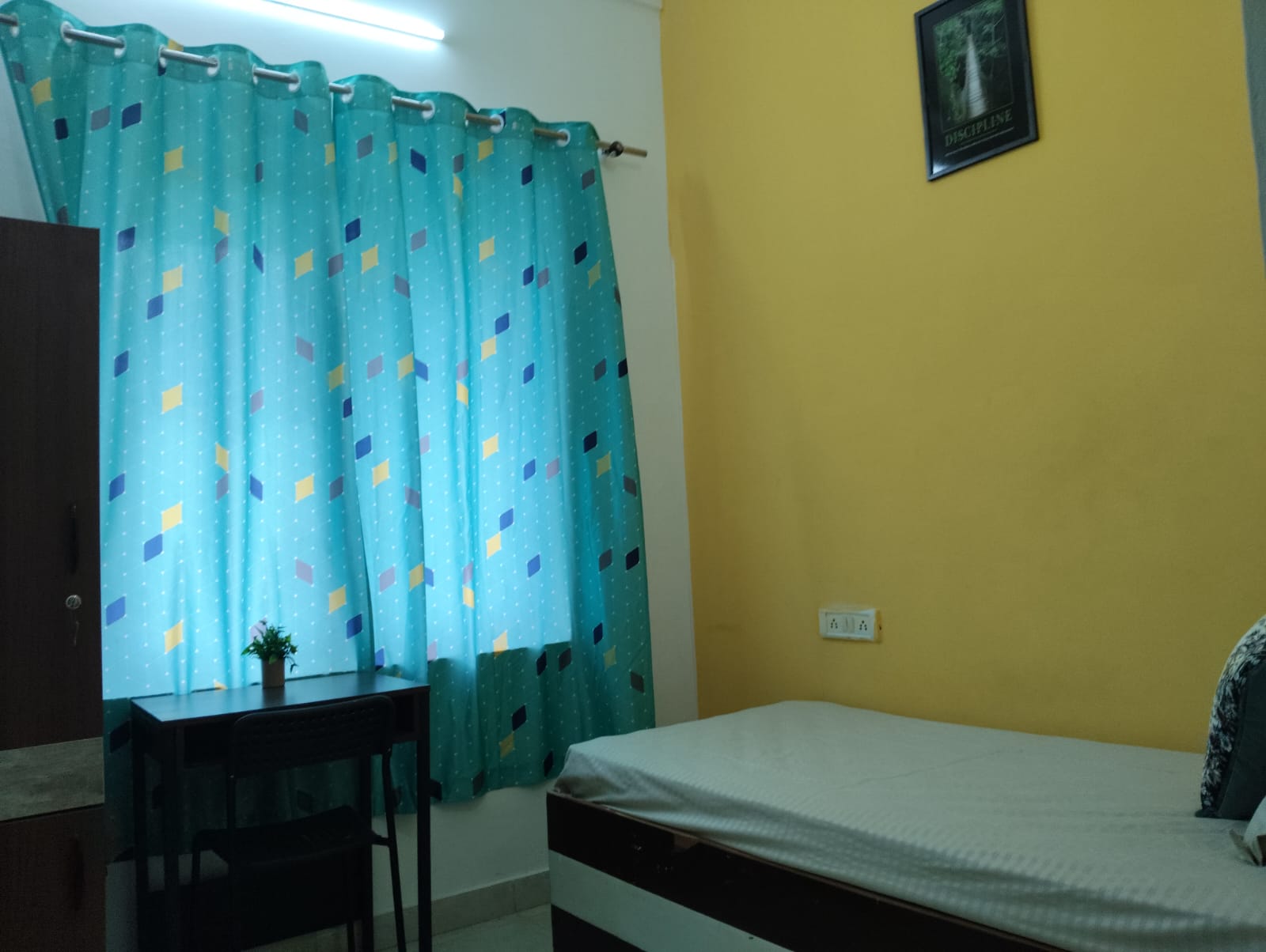 Student room with window and study table at Stag House Hostels