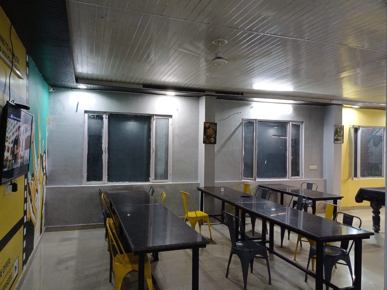 Dining hall with tables and seating at Stag House Hostels