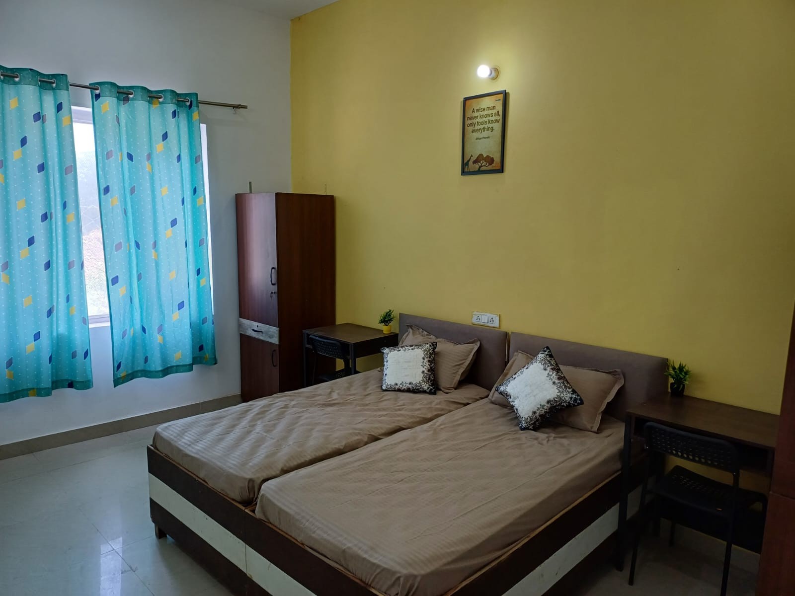 Twin sharing room with beds and study furniture at Stag House Hostels